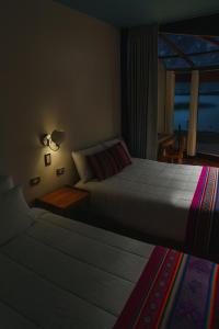 Postel nebo postele na pokoji v ubytování Homestay Luquina Experience