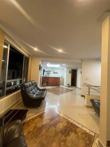 a living room with two chairs and a couch at HOTEL MONTERREY in Ruiosucio