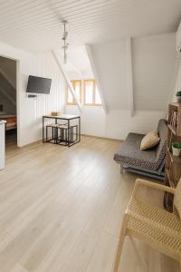 a living room with a couch and a table at Giorgos House Attic in Gialova