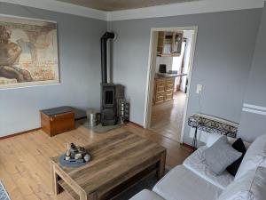 a living room with a couch and a wood stove at Das Dorfkind in Hamm
