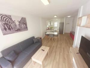 a living room with a couch and a table at Spacious 3BR Condo With Pool, Wifi & Near Beach in Callao Salvaje