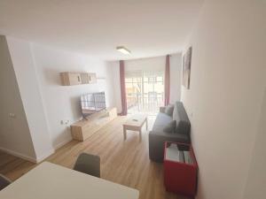 a living room with a couch and a table at Spacious 3BR Condo With Pool, Wifi & Near Beach in Callao Salvaje