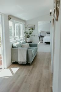 a living room with a couch and a bedroom at The Pickers Rest in Tasman