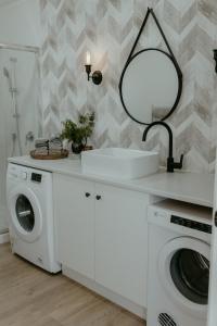 a bathroom with a washing machine and a mirror at The Pickers Rest in Tasman