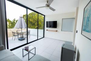 a living room with a couch and a table at Casa Itzae Hotel Boutique in Mérida