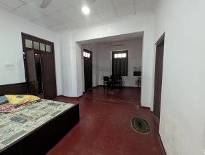 a bedroom with a bed and a dining room at Marvella dickwella in Dickwella