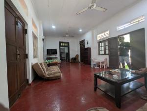 a man standing in a living room with a table at Marvella dickwella in Dickwella