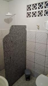 a bathroom with a sink and a toilet in it at Casa Alegria - Praia de Catuama -PE in Goiana