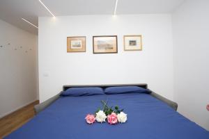a bedroom with a blue bed with flowers on it at Ski Gate - Main Street by Cervino View Experience in Breuil-Cervinia +14 photos
