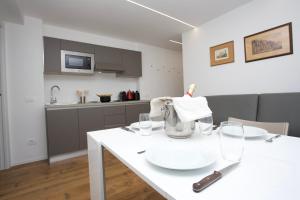 a kitchen with a white table with glasses on it at Ski Gate - Main Street by Cervino View Experience in Breuil-Cervinia