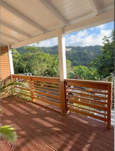 a porch with a view of the mountains at la Canne a sucre in Pointe-Noire