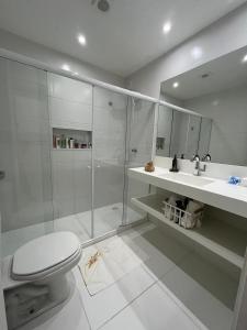 a bathroom with a shower and a toilet and a sink at Casa Bahia E01 in Mata de Sao Joao