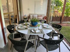 a table and chairs on a patio at Casa Bahia E01 in Mata de Sao Joao