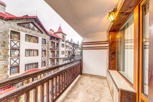 a balcony with a view of a city at Warm Mountain Hideout by Flat Manаger in Pamporovo