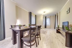 a dining room with a table and chairs at Warm Mountain Hideout by Flat Manаger in Pamporovo