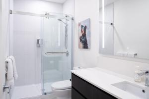 a bathroom with a shower and a toilet and a sink at Bluebird by Revelstoke Vacations in Revelstoke +21 photos