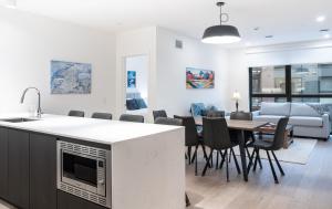 a kitchen and dining room with a table and chairs at Bluebird by Revelstoke Vacations in Revelstoke