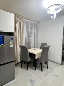 a dining room with a table and chairs and a refrigerator at The Oceanic 42 in Durban