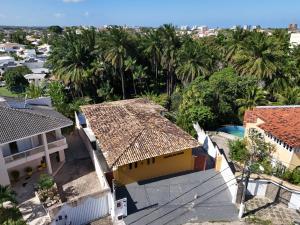 an overhead view of a house with palm trees at Quinta do Conde in Lauro de Freitas