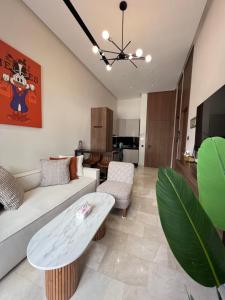 a living room with a couch and a table at A Suites in Casablanca