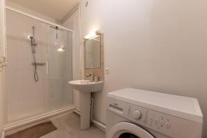 a white bathroom with a sink and a washing machine at Le Vert Calme in Le Havre +21 photos