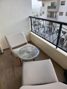a balcony with a table and a chair and a table at super studio in Aïn Harrouda