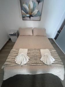 a bedroom with a bed with two pillows on it at Serenity Apartment in Funchal