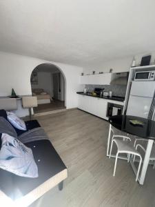 a living room with a couch and a dining room at Serenity Apartment in Funchal