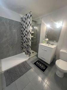 a bathroom with a shower and a toilet and a sink at Serenity Apartment in Funchal
