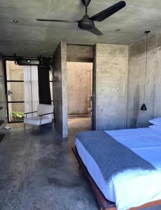 a bedroom with a bed and a ceiling fan at Nativo Tayrona in Santa Marta