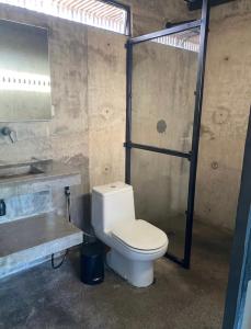 a bathroom with a toilet and a sink and a shower at Nativo Tayrona in Santa Marta