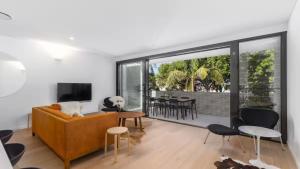 a living room with a couch and a television at The Avenue in Sawtell