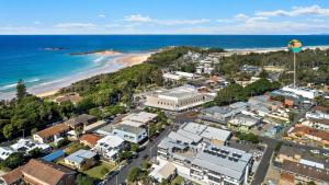 an aerial view of a city and the beach at The Avenue in Sawtell