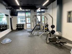 a gym with treadmills and machines in a room at Kasa Bellevue Seattle in Bellevue