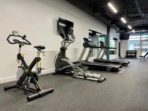 a gym with several exercise bikes and a flat screen tv at Kasa Bellevue Seattle in Bellevue