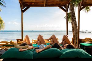 a group of people laying on the beach at Mayan Monkey Isla Mujeres - Social Hotel in Isla Mujeres