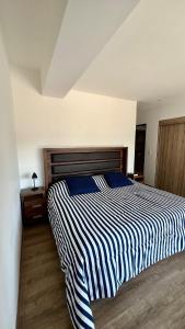 グアダラハラにある#1 in Andares Pool-Jacuzzi-We invoice free of chargeのベッドルーム1室(青と白のストライプの掛け布団付きのベッド1台付) +12枚の写真