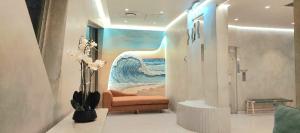 a room with a painting of the ocean and a couch at SolSands Hotel & Self-Catering in Durban