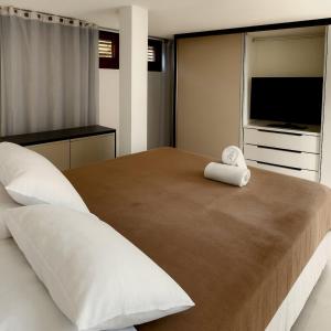 En eller flere senge i et værelse på Casa Bonfim - Excelente opção no centro de Arraial