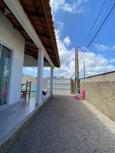 un porche de una casa con mesa y sillas en Casa com Piscina em Itapirubá, en Imbituba