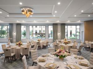 a dining room with tables and chairs and windows at Fairmont Chicago Millennium Park in Chicago