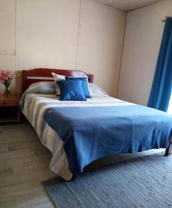 En eller flere senge i et værelse på Casa Montañas del Tricahue