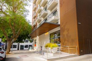 特拉维夫ABBA Hotel Tel Aviv-Yafo - Formerly Numa的一座建筑的正面,前面有植物