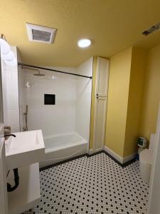 a bathroom with a tub and a sink and a toilet at The Einstein Room in Boise