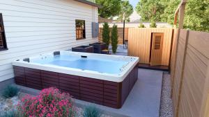 a hot tub in a backyard with a fence at The Einstein Room in Boise