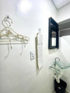 a bathroom with a glass sink and a mirror at Mar Doce Lar Kitinete in São Vicente