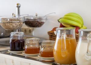 a tray with jars of honey and apples and bananas at Anaktorikon Boutique Hotel in Tripolis