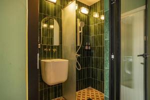a bathroom with a shower with a toilet and a sink at Still apartment in Guangzhou