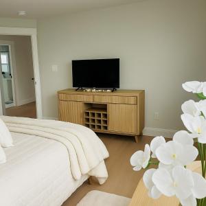 una camera da letto con un letto e una TV a schermo piatto di Blue Ridge Main St Mountain View Cottage a Sparta