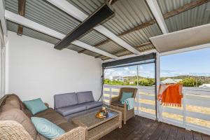 a living room with a couch and chairs on a balcony at Love You Moore in Guilderton